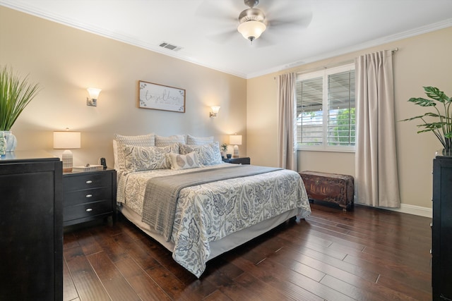 bedroom with ornamental molding, visible vents, dark wood-style flooring, ceiling fan, and baseboards