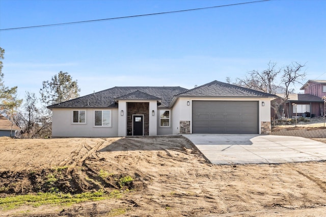 view of front of home featuring a garage, concrete driveway, stone siding, and stucco siding