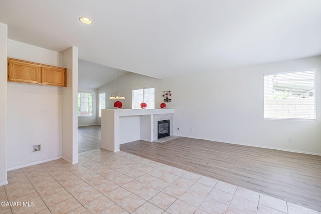 38537 E 37th St, Palmdale, CA 93550 - unfurnished living room featuring a chandelier, light tile patterned flooring, lofted ceiling, a tile fireplace, and recessed lighting