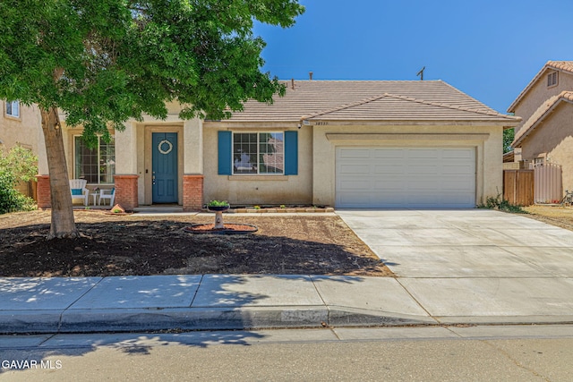 38537 E 37th St, Palmdale, CA 93550 - view of front facade with a tile roof, concrete driveway, stucco siding, and a garage