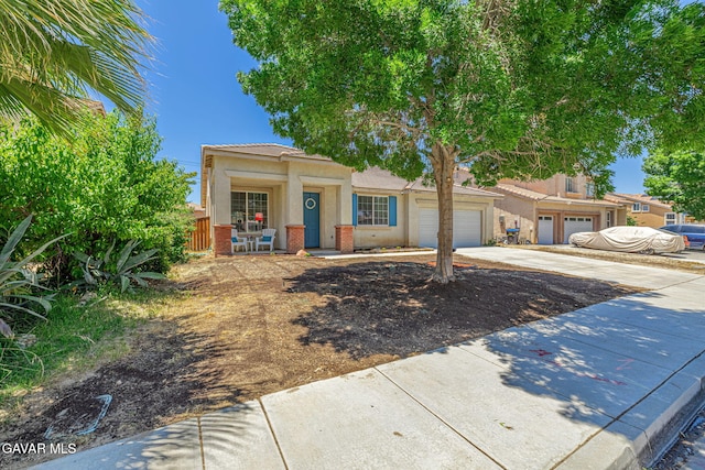 38537 E 37th St, Palmdale, CA 93550 - view of front of home with stucco siding, concrete driveway, a garage, covered porch, and brick siding
