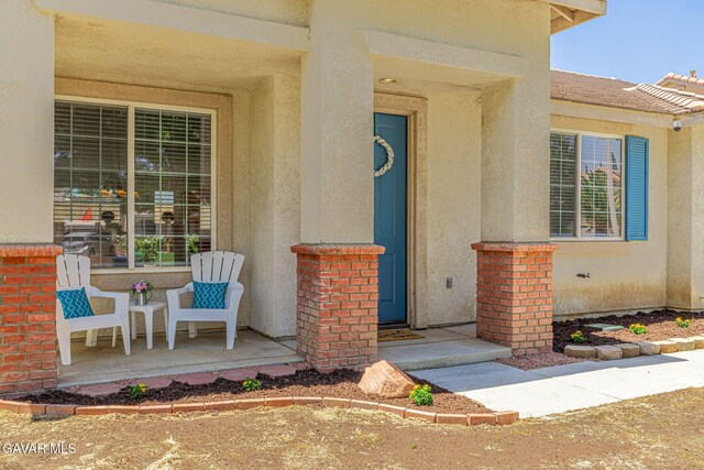 38537 E 37th St, Palmdale, CA 93550 - doorway to property featuring stucco siding and a porch