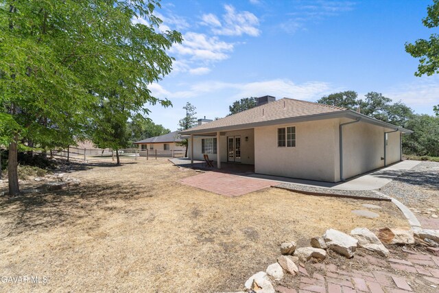 22401 Citation St, Tehachapi, CA 93561 - rear view of house with french doors, a patio area, stucco siding, and a chimney