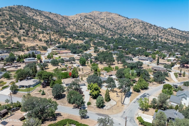 22401 Citation St, Tehachapi, CA 93561 - aerial overview of property's location featuring a mountain backdrop and nearby suburban area