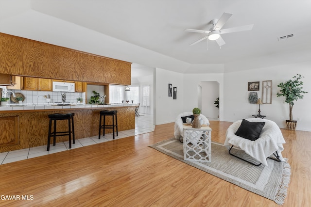 22401 Citation St, Tehachapi, CA 93561 - living area featuring a ceiling fan, light wood-type flooring, and arched walkways