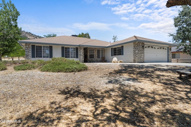 22401 Citation St, Tehachapi, CA 93561 - ranch-style house with stone siding, an attached garage, concrete driveway, and stucco siding