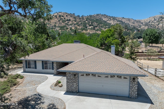 22401 Citation St, Tehachapi, CA 93561 - ranch-style house with driveway, an attached garage, a chimney, stone siding, and a mountain view