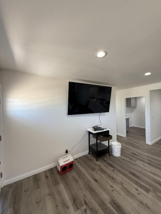 2202 E Lancaster Blvd, Lancaster, CA 93535 - unfurnished living room featuring wood finished floors, baseboards, recessed lighting, and a textured ceiling