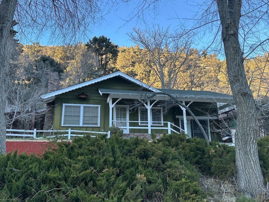 3801 Los Padres Dr, Frazier Park, CA 93225 - view of front of property with fence, covered porch, and a chimney