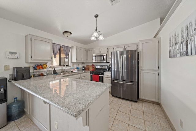 kitchen featuring pendant lighting, sink, kitchen peninsula, and stainless steel appliances