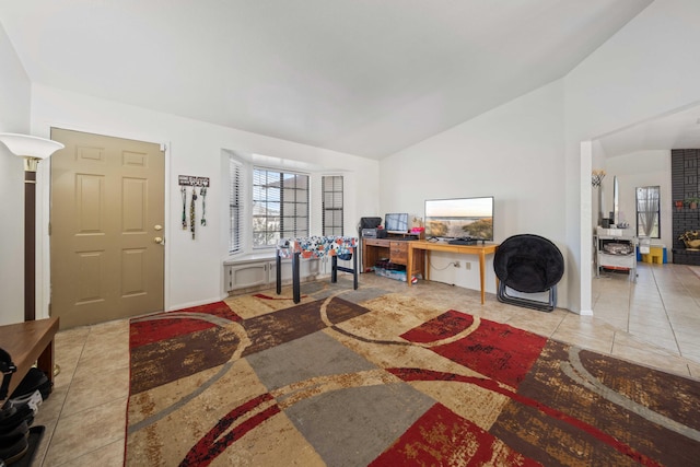 office with lofted ceiling and light tile patterned flooring