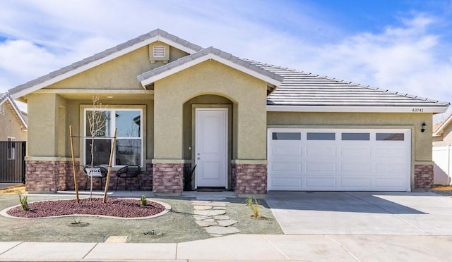 view of front facade with stone siding, driveway, an attached garage, and stucco siding