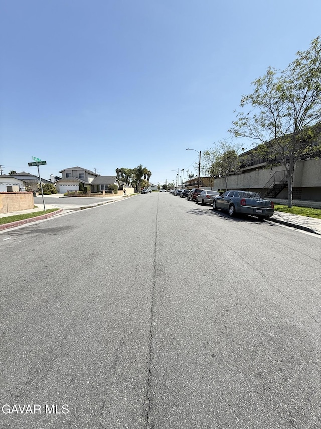 1239 W Rosecrans Ave Unit 31, Gardena, CA 90247 - view of asphalt street with sidewalks, curbs, street lighting, and a residential view