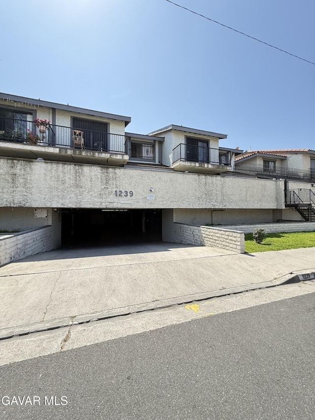 1239 W Rosecrans Ave Unit 31, Gardena, CA 90247 - view of building exterior with an attached garage and driveway