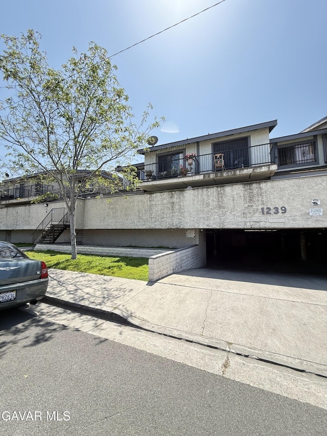 1239 W Rosecrans Ave Unit 31, Gardena, CA 90247 - view of front of home with an attached garage and concrete driveway