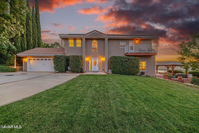 42725 Deer Walk Rd, Lake Hughes, CA 93532 - view of front of property featuring driveway, stucco siding, an attached garage, a lawn, and a gazebo