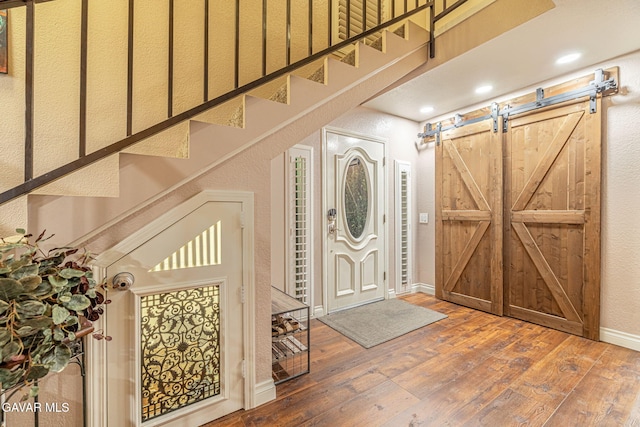 42725 Deer Walk Rd, Lake Hughes, CA 93532 - entryway featuring hardwood / wood-style floors, a barn door, stairs, and recessed lighting