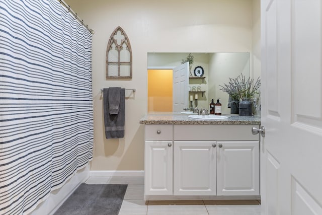 full bathroom featuring vanity, baseboards, a shower with curtain, and tile patterned floors