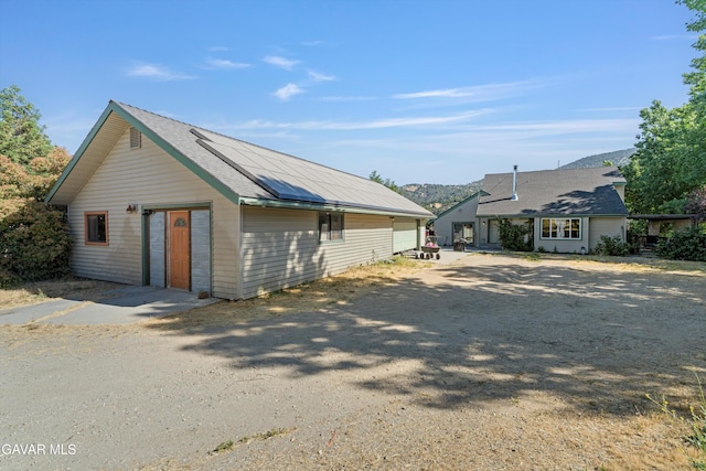 24750 Flatiron Ct, Tehachapi, CA 93561 - view of front of property with an outbuilding, a detached garage, and solar panels