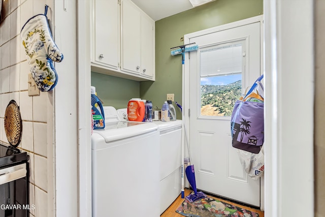 24750 Flatiron Ct, Tehachapi, CA 93561 - washroom with washer and dryer, cabinet space, and light wood-type flooring