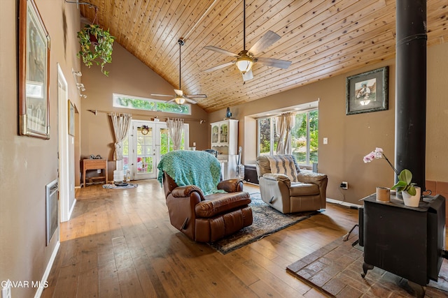 24750 Flatiron Ct, Tehachapi, CA 93561 - living room with ceiling fan, wood-type flooring, a wood stove, healthy amount of natural light, and high vaulted ceiling