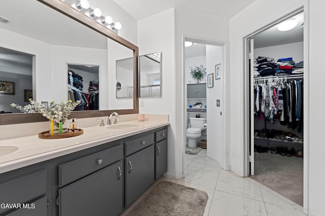 3267 Desert Cloud Ave, Rosamond, CA 93560 - full bath with double vanity, marble look tile flooring, and a walk in closet