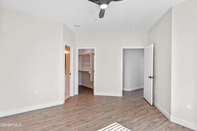 9207 Margery Ave, California City, CA 93505 - unfurnished bedroom featuring light wood-style floors, a spacious closet, ceiling fan, and a closet