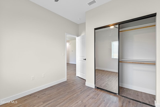 9207 Margery Ave, California City, CA 93505 - unfurnished bedroom with wood finished floors and a closet