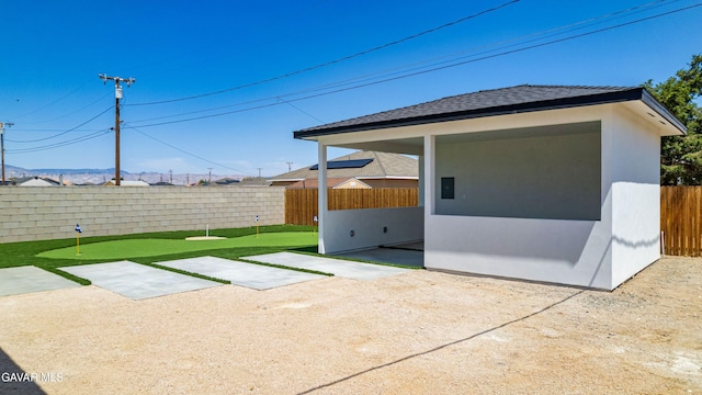 9207 Margery Ave, California City, CA 93505 - fenced backyard featuring a putting green and a patio