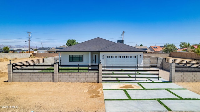 9207 Margery Ave, California City, CA 93505 - view of front of house featuring a fenced front yard, roof with shingles, a garage, and stucco siding