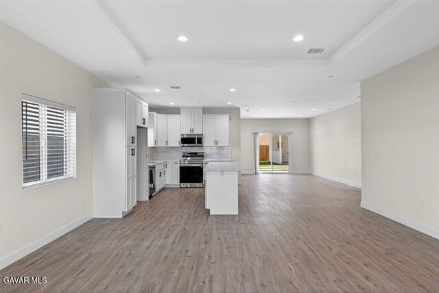 9207 Margery Ave, California City, CA 93505 - kitchen featuring range, stainless steel microwave, open floor plan, healthy amount of natural light, and recessed lighting