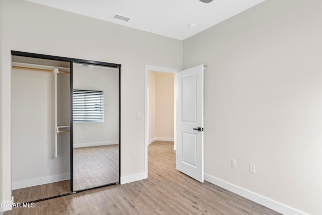 9207 Margery Ave, California City, CA 93505 - unfurnished bedroom featuring wood finished floors and a closet