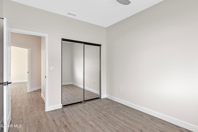 9207 Margery Ave, California City, CA 93505 - unfurnished bedroom featuring light wood-style floors and a closet