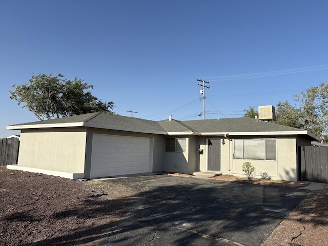 38810 Foxholm Dr, Palmdale, CA 93551 - ranch-style home with an attached garage, driveway, central AC, roof with shingles, and stucco siding