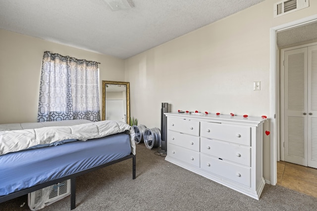 carpeted bedroom featuring a textured ceiling