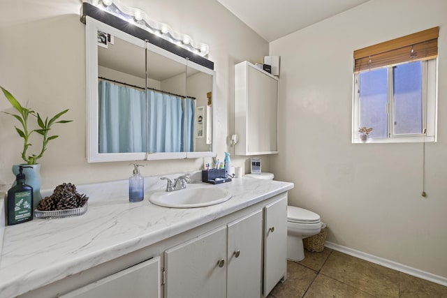 bathroom with toilet, tile patterned flooring, and vanity