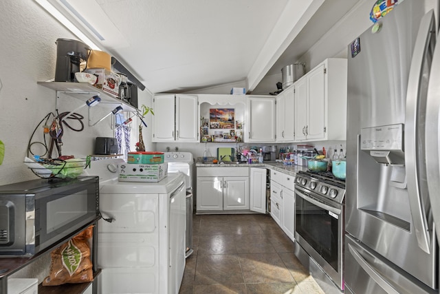 kitchen featuring white cabinets, appliances with stainless steel finishes, washer / dryer, and sink