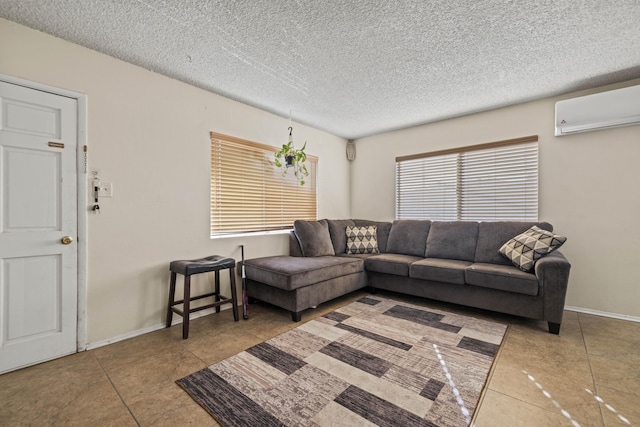 living room featuring a textured ceiling, a wall unit AC, and light tile patterned floors