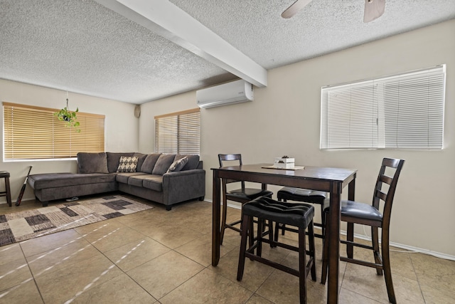 tiled dining space featuring beam ceiling, ceiling fan, a textured ceiling, and a wall unit AC