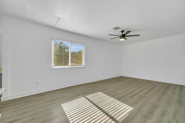 empty room with light hardwood / wood-style floors and ceiling fan