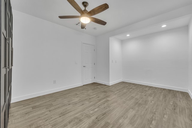 spare room featuring ceiling fan and light wood-type flooring