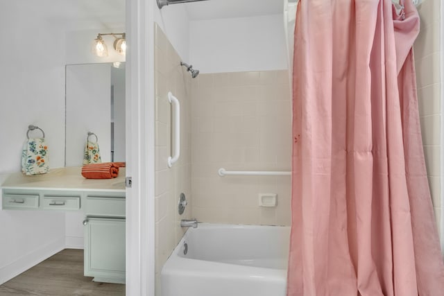 bathroom with wood-type flooring, shower / bath combo, and vanity