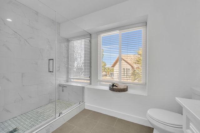 bathroom with tile patterned floors, toilet, an enclosed shower, and vanity