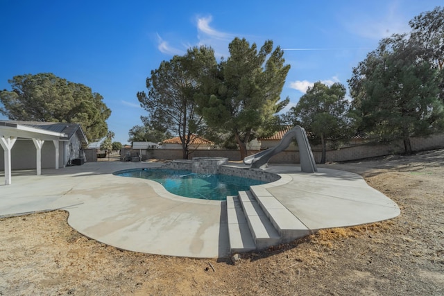 view of pool with a patio area and a water slide