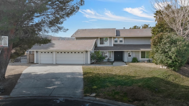 view of property featuring a garage and a front yard