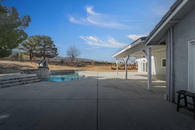 view of pool featuring a patio and a water slide