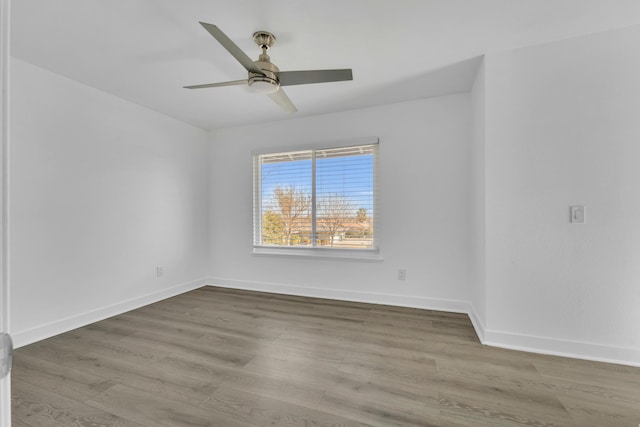 unfurnished room with hardwood / wood-style flooring and ceiling fan