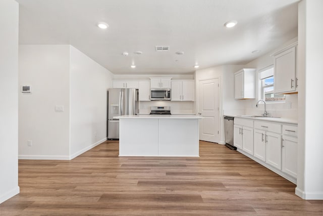 6018 Vespucci Ave, Bakersfield, CA 93313 - kitchen featuring appliances with stainless steel finishes, a sink, baseboards, light countertops, and recessed lighting