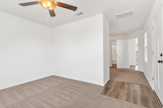 6018 Vespucci Ave, Bakersfield, CA 93313 - carpeted empty room with ceiling fan, wood finished floors, and baseboards