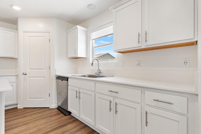 6018 Vespucci Ave, Bakersfield, CA 93313 - kitchen featuring a sink, stainless steel dishwasher, white cabinets, light wood finished floors, and light countertops